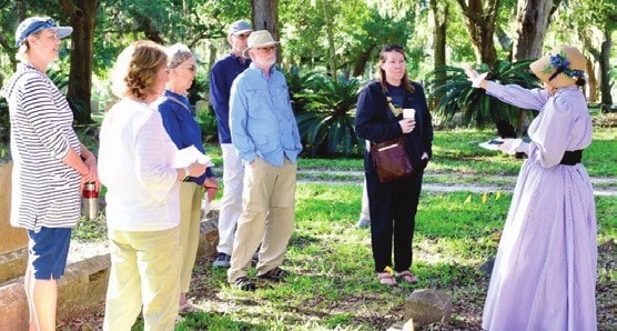 Costumed presenter leading a tour at Bosque Bello Cemetery
